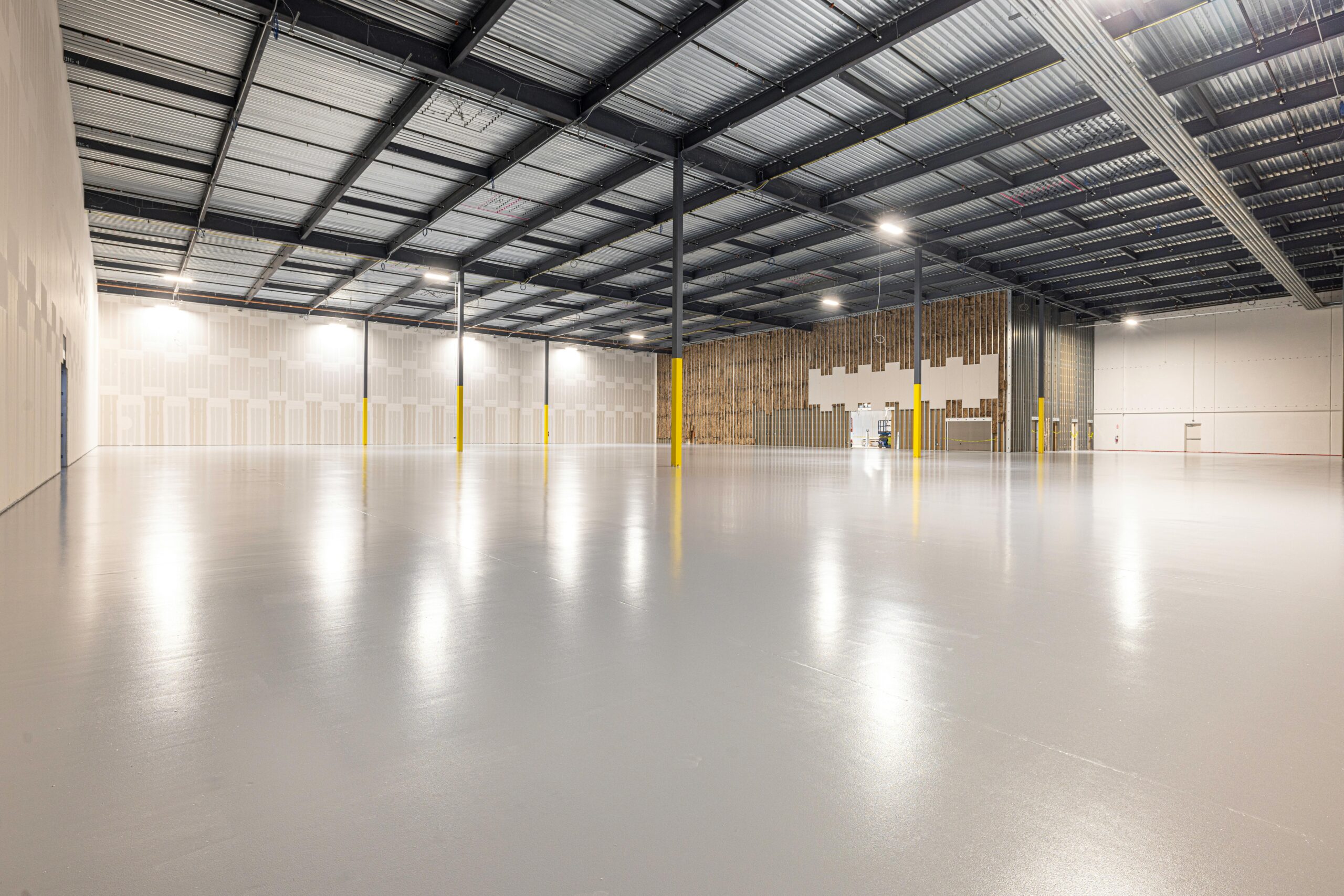 Empty modern warehouse interior with polished floor and ample space located in Texas.